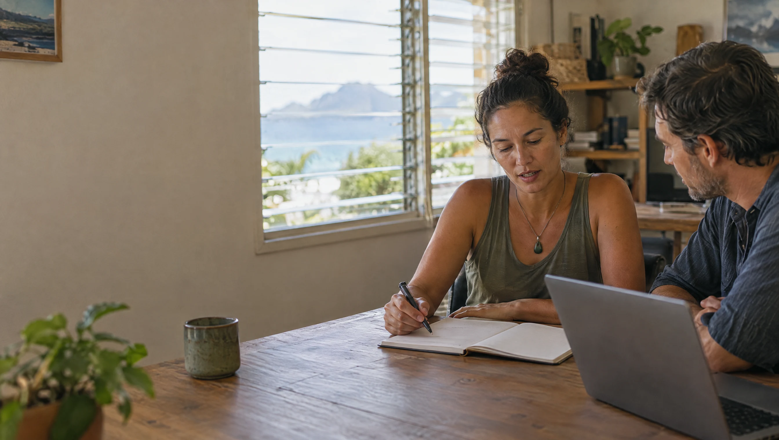 Illustrative scene of a Hawaii small business owner and strategist reviewing a blank planning notebook