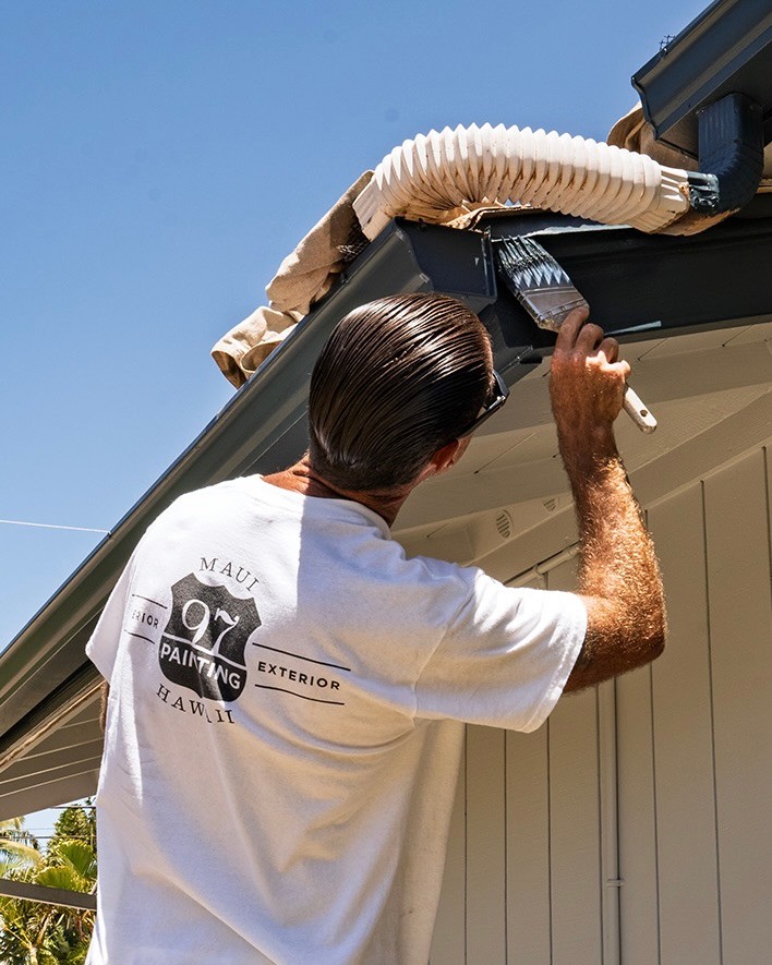 Digital Reach, Painter touching up exterior trim, Maui Painting Hawaii.