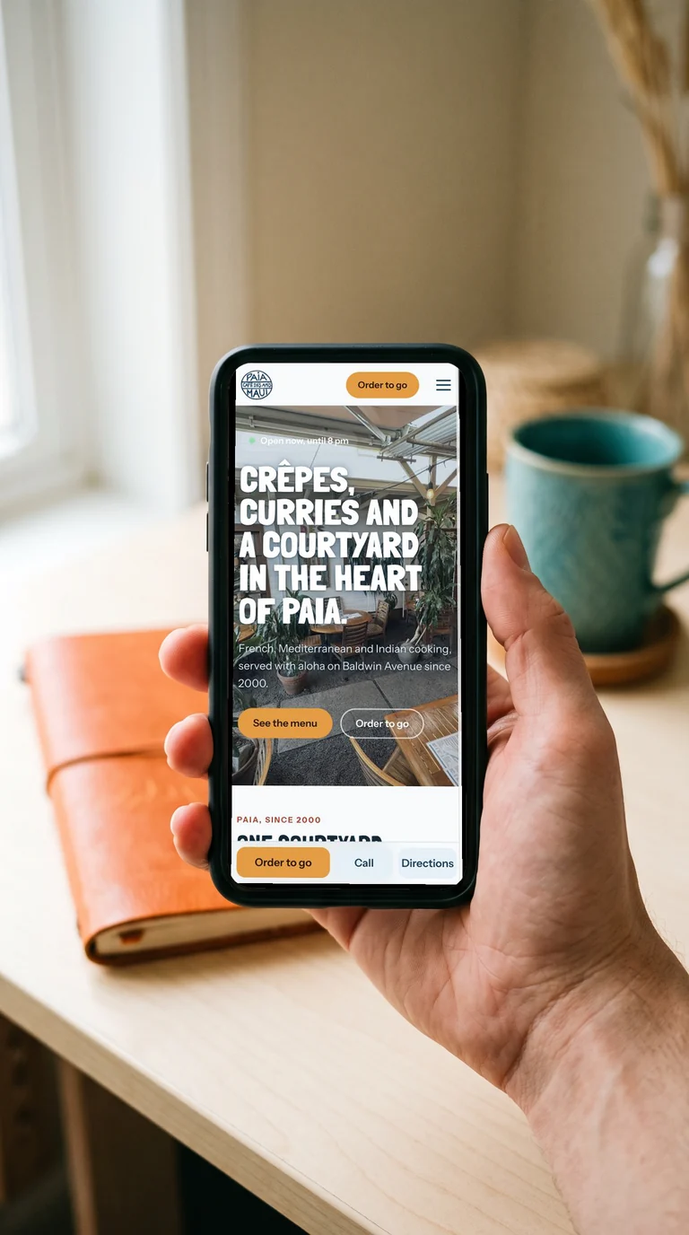 Café des Amis responsive website displayed on a phone