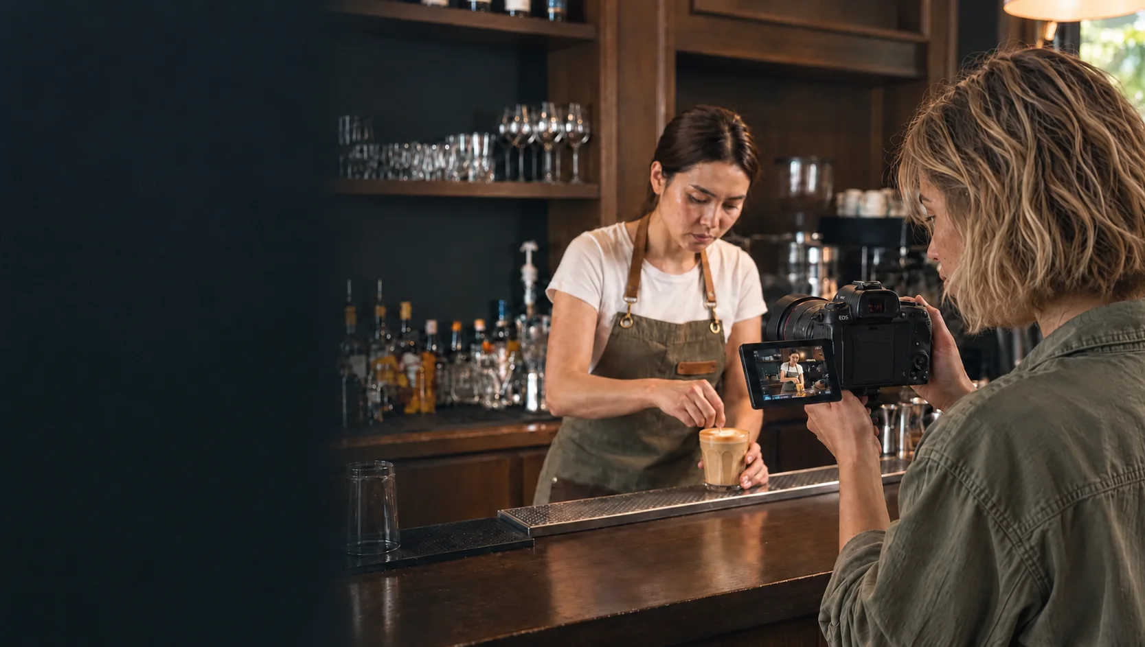 Maui cafe content shoot: a creator films a barista with a Canon camera whose live-view screen shows the barista