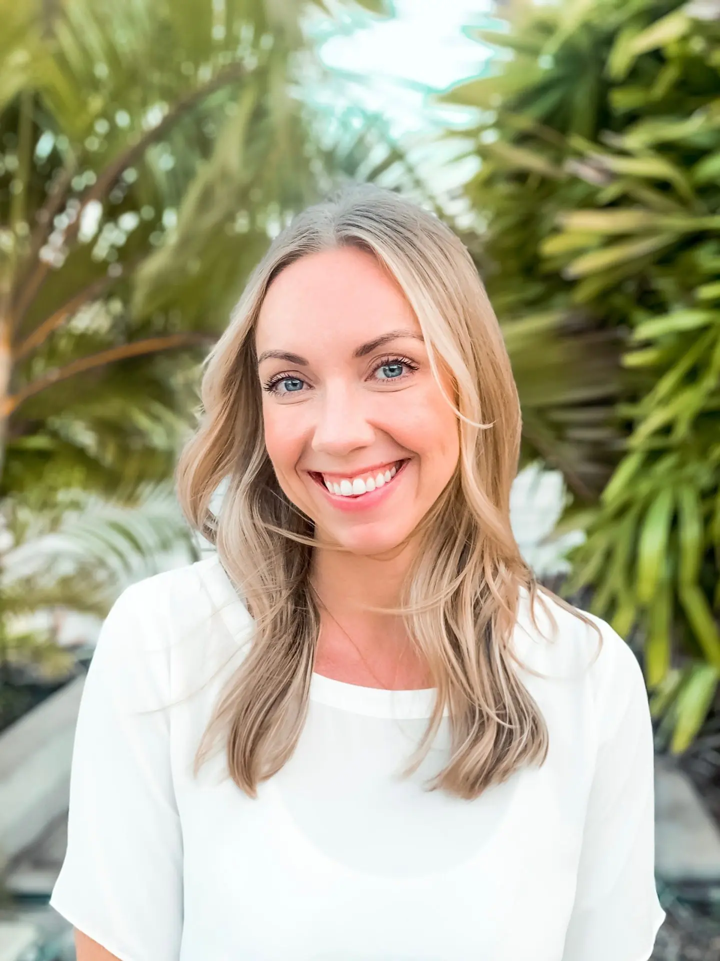Digital Reach Smiling blonde woman in white top