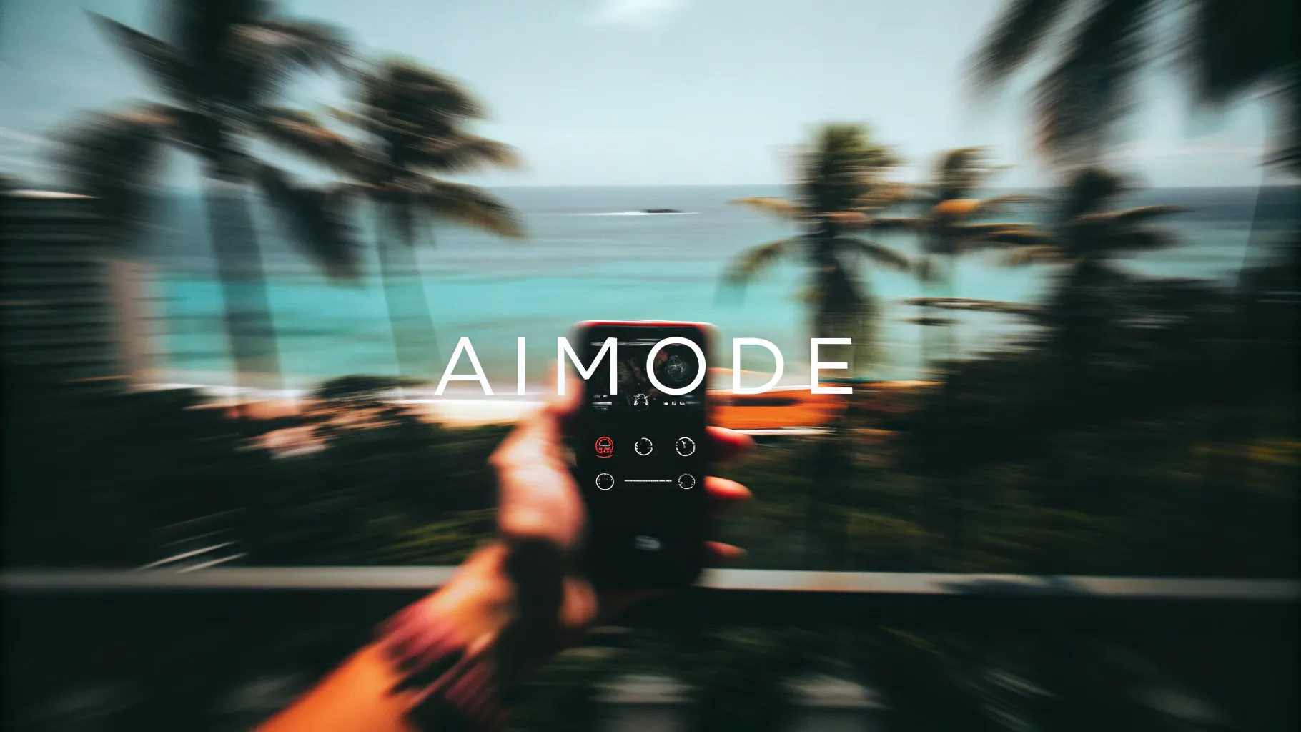 Digital Reach, Person holding phone displaying Aimode app against blurred tropical beach background.
