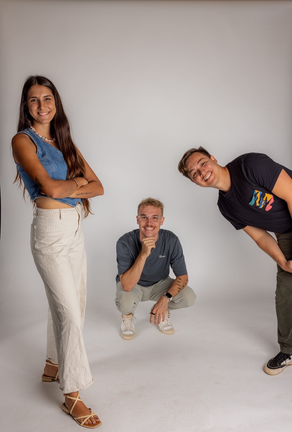 1F4A7977 Copy Digital Reach, Group of three young adults smiling on a white background. Hawaii social media marketing services.