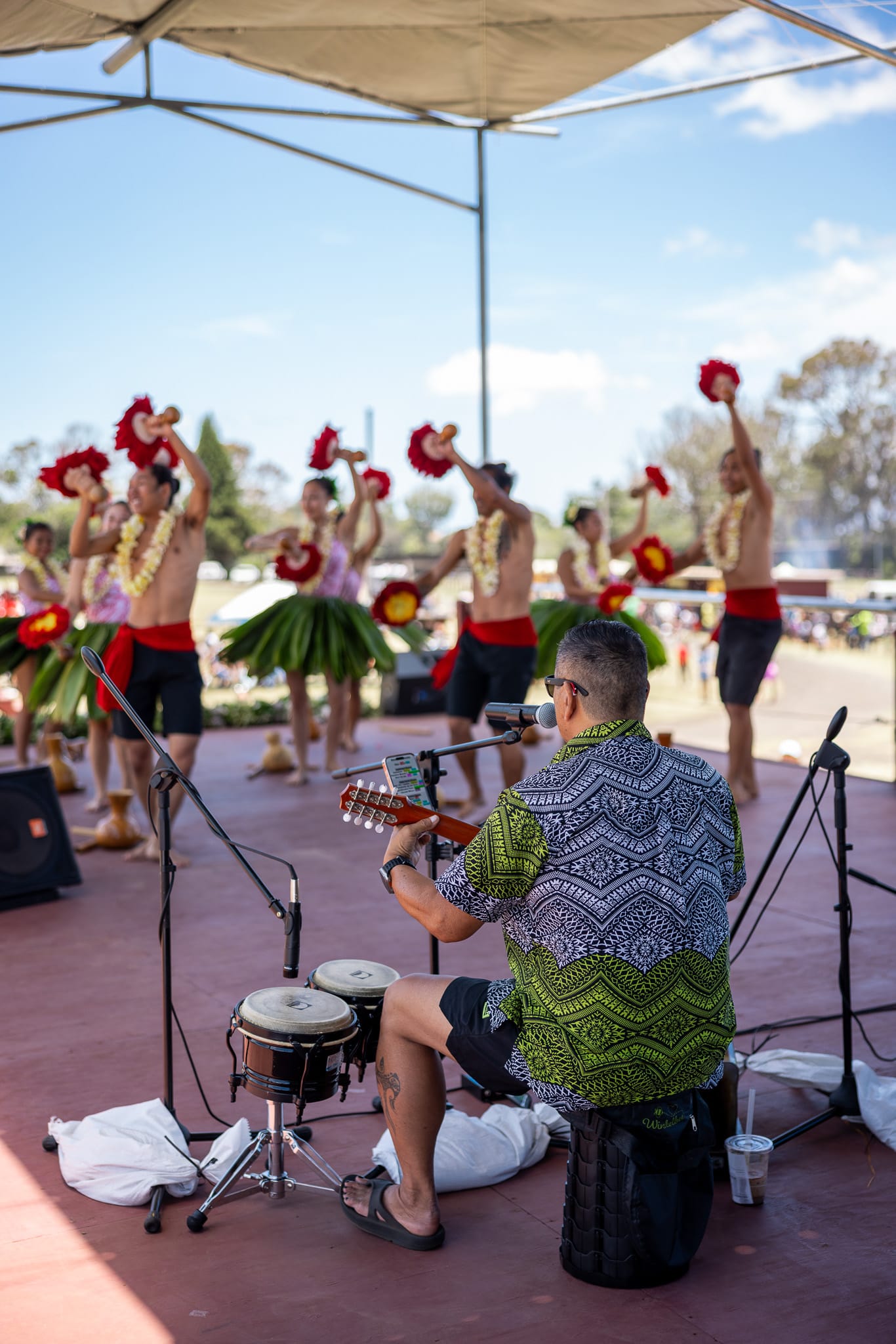 IMG_9377 • Digital Reach Digital Reach, Hawaiian dancers perform on stage with a musician playing guitar and bongo drums, promoting Hawaii social media marketing services.